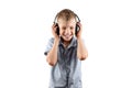 White smiling boy listens to music in big headphones Isolated on a white background. Musician, the future of the child, music Royalty Free Stock Photo