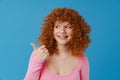 White smiling woman with ginger hair showing thumb up at camera Royalty Free Stock Photo