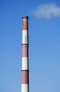 White smoke from the boiler room chimney against the blue sky. Royalty Free Stock Photo