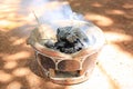 White smoke and burning charcoals on retro stove for cooking in countryside thailand