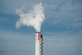 white smoke of chemical factory chimney on blue sky background