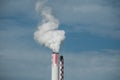 white smoke of chemical factory chimney on blue sky background