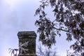 White smoke from the chimney of an old house during frost Royalty Free Stock Photo