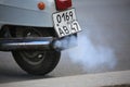 White smoke coming from the exhaust pipe of a scooter, close-up