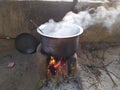 White smoke coming out from the pan. Cooking Rajasthani food on mud challah or stove or oven