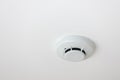 White smoke detector on ceiling. Fire smoke sensor on ceiling. Ceiling white fire detector used to activate warning systems in bui Royalty Free Stock Photo