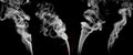 Four white smokes set on black background , graphic ressource . Royalty Free Stock Photo