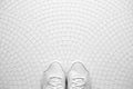 White sneackers on white mosaic pattern Royalty Free Stock Photo