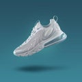 White sneaker on a blue gradient background, men`s fashion, sport shoe, nike sneakers, lifestyle Royalty Free Stock Photo