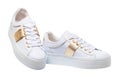 White sneaker isolated. Close-up of a pair white elegant stylish female leather high-heeled sport shoes isolated. Clipping path.