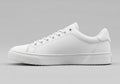 White sneaker with a minimalist design, featuring a smooth leather upper and a rubber sole. The Royalty Free Stock Photo
