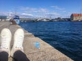 White sneakers on the background of the sea. Holidays in Europe.