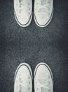 White sneakers on black cement isolated on back floor with copy space. Royalty Free Stock Photo