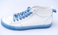 White sneakers with blue laces. Sports casual shoes.