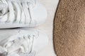 White sneakers, jute knitted carpet