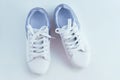 White sneakers with laces with silver inserts on white background. View from above Royalty Free Stock Photo