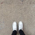 White Sneakers shoes walking on ground top view