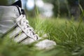 White sneakers in spring grass. Royalty Free Stock Photo