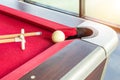 White snooker ball and cue stick with rest near the corner hole Royalty Free Stock Photo