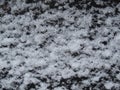 White snow on a black metal surface. Abstract winter grunge background. Royalty Free Stock Photo