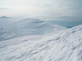 White snow covered mountain peaks on high. Cold winter background Royalty Free Stock Photo