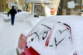 White snow with drown heart shape. heart drawn in the snow by car on a city street. background for valentines day, New Year Christ