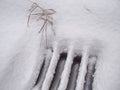 White snow on metal grate outside pavement road Royalty Free Stock Photo