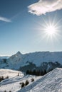 Snow and sun on the top of the mountains and fog down the valley Royalty Free Stock Photo