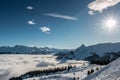 Snow and sun on the top of the mountains and fog down the valley Royalty Free Stock Photo