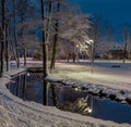 White snow winter night park with pond, bridge and lantern Royalty Free Stock Photo