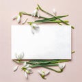 White snowdrop flowers arranged around a blank white rectangular card on a light pink background. Generative AI