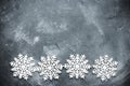 White snowflakes border on concrete background