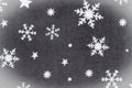 White snowflakes on gray material holiday background