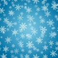 Snowflakes of various intricate designs are scattered across a blue Royalty Free Stock Photo
