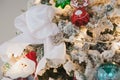 White snowy Christmas tree with vintage key, toys, tapes, balls, garlands on a spruce branches with artificial snow Royalty Free Stock Photo