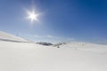 White snowy fields under a blue sky