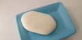 A white soap in a blue mini saucer Royalty Free Stock Photo