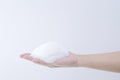 White soapy foam bubbles texture on hand.  cleaning and wash essence facial cleanser background concept Royalty Free Stock Photo