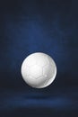 White soccer ball on a dark blue studio background Royalty Free Stock Photo