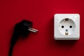 white socket and black plug  on red background Royalty Free Stock Photo