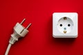 white socket and black plug  on red background Royalty Free Stock Photo