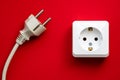white socket and black plug  on red background Royalty Free Stock Photo