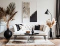 White sofa and black coffee table against white wall with art poster. Scandinavian boho home interior design of modern living room Royalty Free Stock Photo