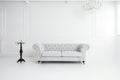 a white sofa, fashionable comfortable and stylish, by the white wall