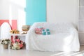 white sofa with gifts coffee table with flowers and books in a bright room interior blue as backgrounds Royalty Free Stock Photo