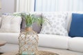 White sofa with many blue pillows in cozy living room Royalty Free Stock Photo