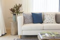 White sofa with many blue pillows in cozy living room Royalty Free Stock Photo