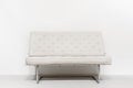 White sofa near white wall in interior. Minimalism modern design