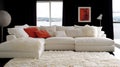 White sofa, red pillows, room, sea view, home decor Royalty Free Stock Photo