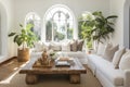 White sofa and rustic wooden stamp coffee table against arched window. Hollywood glam interior design of modern living room